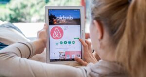 a traveler booking an airbnb rental on an ipad
