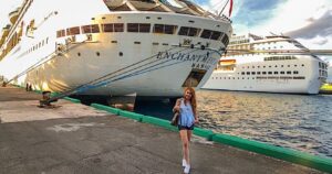woman-at-dock-standing-in-front-of-royal-caribbean-ship