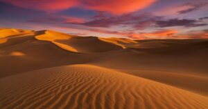 the sunset over the sahara desert