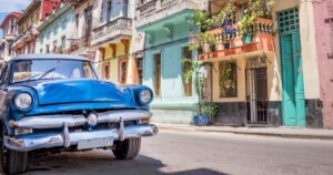 a vintage car on a colorful street in havana, cuba